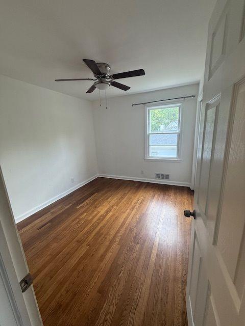 2190 Olive Springs Rd SE, Marietta, GA 30060 - unfurnished room with dark wood-type flooring, a ceiling fan, and baseboards