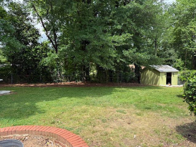 2190 Olive Springs Rd SE, Marietta, GA 30060 - view of yard featuring a storage unit and an outdoor structure