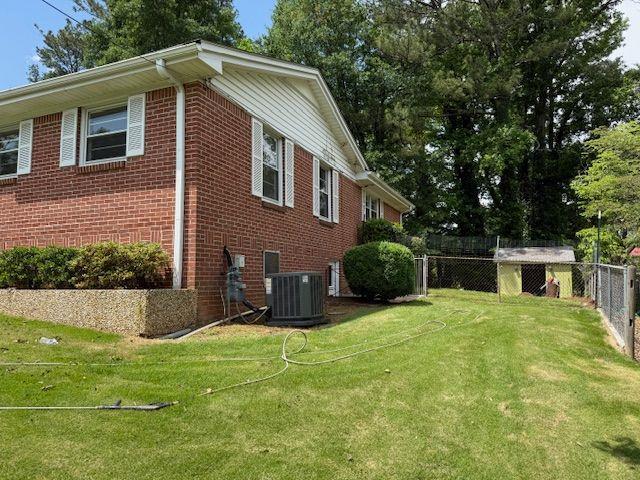 2190 Olive Springs Rd SE, Marietta, GA 30060 - view of home's exterior featuring central air condition unit and brick siding
