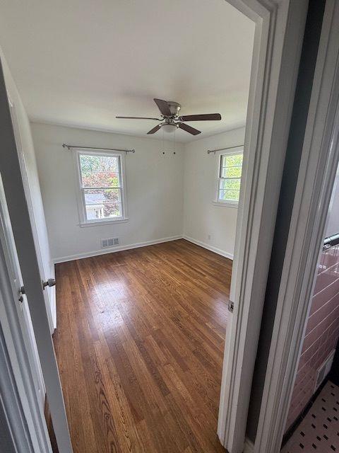 2190 Olive Springs Rd SE, Marietta, GA 30060 - spare room featuring plenty of natural light, dark wood-type flooring, and baseboards