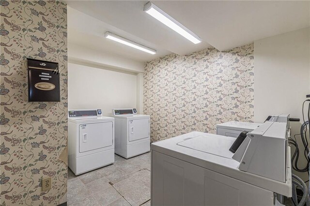 laundry room with light tile patterned floors and washing machine and clothes dryer