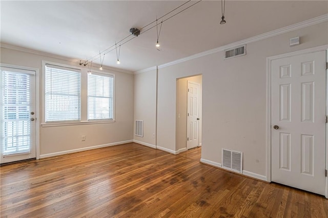 empty room featuring hardwood / wood-style flooring and ornamental molding