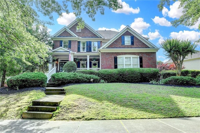 4770 Spring Park Cir, Suwanee, GA 30024 - view of front of property featuring brick siding, a front yard, and covered porch