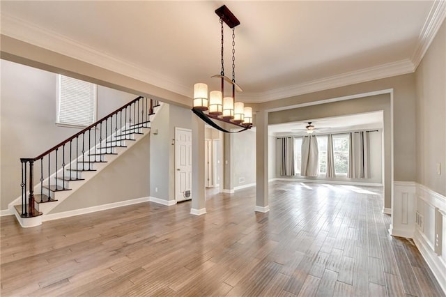 4770 Spring Park Cir, Suwanee, GA 30024 - unfurnished dining area with stairway, ornamental molding, wood finished floors, and ceiling fan