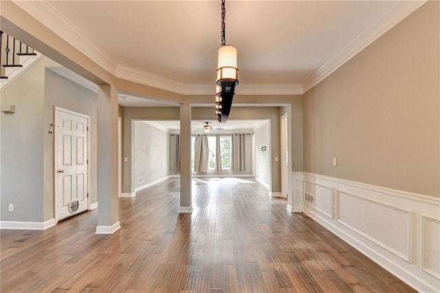 4770 Spring Park Cir, Suwanee, GA 30024 - unfurnished dining area featuring crown molding, wood finished floors, stairway, ceiling fan, and wainscoting