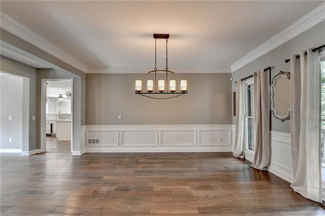 4770 Spring Park Cir, Suwanee, GA 30024 - unfurnished dining area with hardwood / wood-style flooring, a chandelier, and crown molding