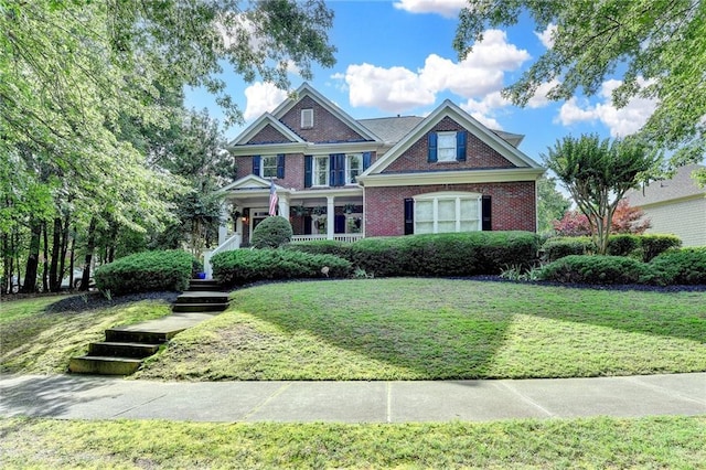 4770 Spring Park Cir, Suwanee, GA 30024 - view of front of house featuring a front lawn, brick siding, and covered porch