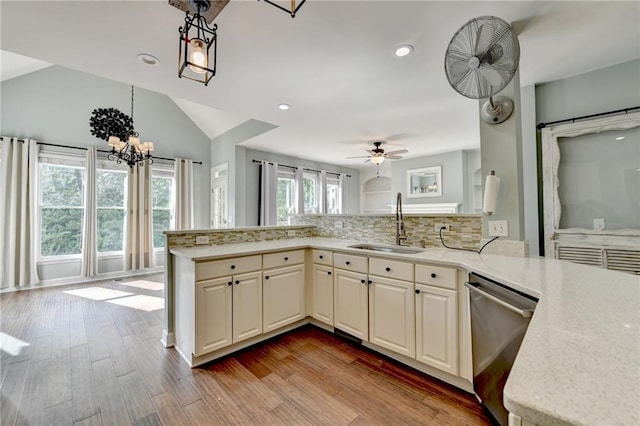 4770 Spring Park Cir, Suwanee, GA 30024 - kitchen featuring dishwasher, a peninsula, backsplash, light stone countertops, and lofted ceiling