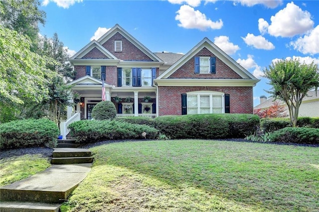 4770 Spring Park Cir, Suwanee, GA 30024 - view of front of home with a front yard, brick siding, and a porch