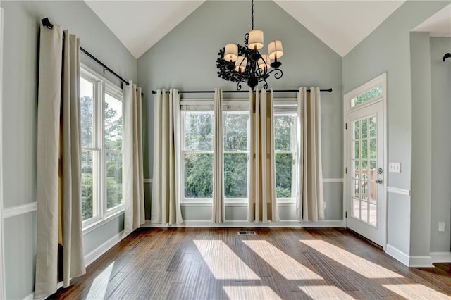 4770 Spring Park Cir, Suwanee, GA 30024 - unfurnished dining area featuring plenty of natural light, a chandelier, dark wood finished floors, and high vaulted ceiling