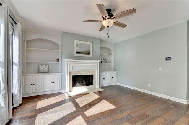 4770 Spring Park Cir, Suwanee, GA 30024 - unfurnished living room with a ceiling fan, a fireplace, dark wood-style floors, and built in shelves