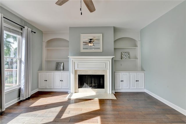 4770 Spring Park Cir, Suwanee, GA 30024 - unfurnished living room with a ceiling fan, a premium fireplace, dark wood-type flooring, and built in features