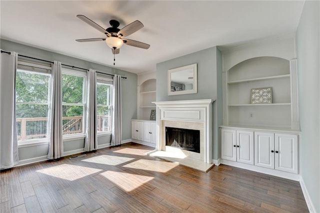 4770 Spring Park Cir, Suwanee, GA 30024 - unfurnished living room with a fireplace, a ceiling fan, built in shelves, and wood finished floors