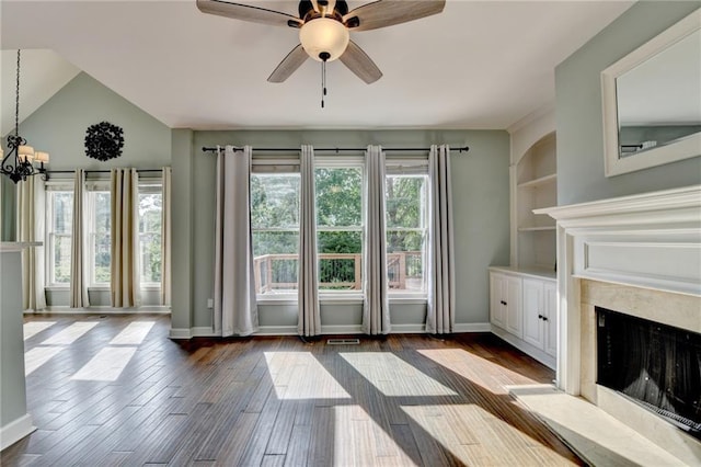 4770 Spring Park Cir, Suwanee, GA 30024 - unfurnished living room featuring a high end fireplace, ceiling fan, a chandelier, dark wood-style flooring, and lofted ceiling