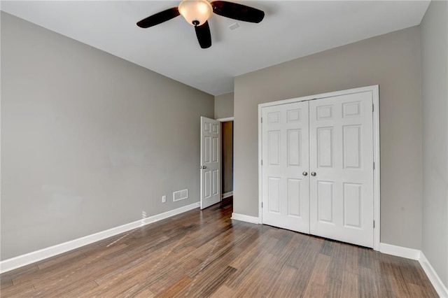 4770 Spring Park Cir, Suwanee, GA 30024 - unfurnished bedroom featuring wood finished floors, a closet, and ceiling fan