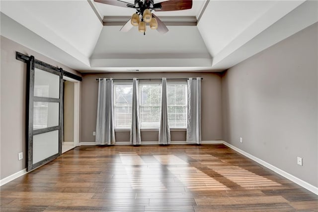 4770 Spring Park Cir, Suwanee, GA 30024 - unfurnished room featuring a ceiling fan, a raised ceiling, lofted ceiling, and wood finished floors