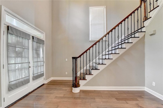 4770 Spring Park Cir, Suwanee, GA 30024 - foyer with wood finished floors, a high ceiling, stairs, plenty of natural light, and french doors