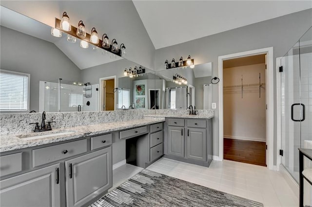 4770 Spring Park Cir, Suwanee, GA 30024 - full bath with vaulted ceiling, a stall shower, double vanity, tile patterned floors, and a walk in closet