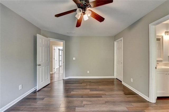 4770 Spring Park Cir, Suwanee, GA 30024 - unfurnished bedroom with wood finished floors, connected bathroom, and a ceiling fan