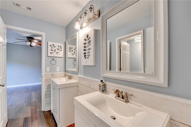 4770 Spring Park Cir, Suwanee, GA 30024 - bathroom featuring two vanities, a ceiling fan, and wood finished floors
