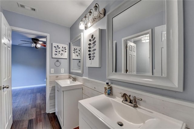 4770 Spring Park Cir, Suwanee, GA 30024 - bathroom with ceiling fan, vanity, wood finished floors, and wainscoting