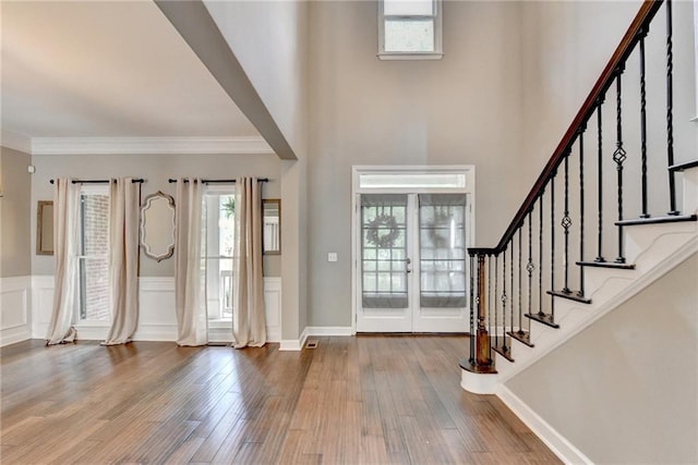 4770 Spring Park Cir, Suwanee, GA 30024 - foyer featuring plenty of natural light, wood finished floors, stairs, ornamental molding, and wainscoting