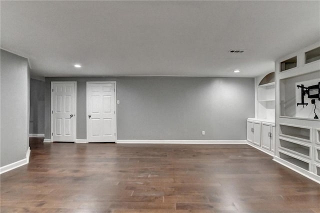 4770 Spring Park Cir, Suwanee, GA 30024 - unfurnished living room with recessed lighting, dark wood-style floors, and built in shelves
