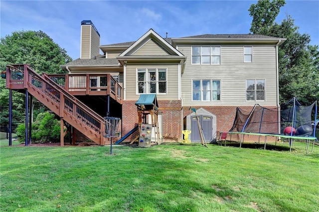 4770 Spring Park Cir, Suwanee, GA 30024 - rear view of property with a trampoline, a chimney, a deck, a lawn, and stairway