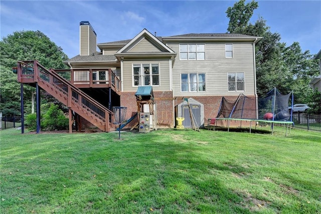 4770 Spring Park Cir, Suwanee, GA 30024 - rear view of property with a trampoline, stairs, a wooden deck, a chimney, and brick siding