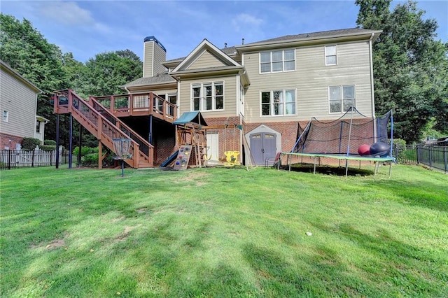 4770 Spring Park Cir, Suwanee, GA 30024 - rear view of property featuring a trampoline, a deck, stairs, a chimney, and brick siding