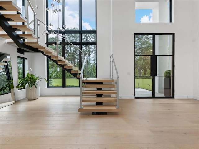 2940 Old Peachtree Rd, Dacula, GA 30019 - stairs featuring a high ceiling, wood finished floors, and baseboards