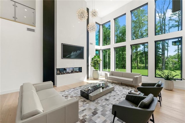 2940 Old Peachtree Rd, Dacula, GA 30019 - living room featuring a high ceiling, plenty of natural light, and light wood finished floors