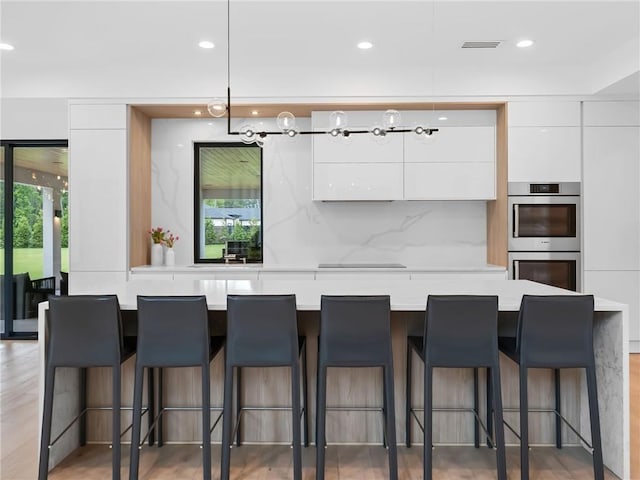 2940 Old Peachtree Rd, Dacula, GA 30019 - kitchen with modern cabinets, stainless steel double oven, white cabinetry, and recessed lighting