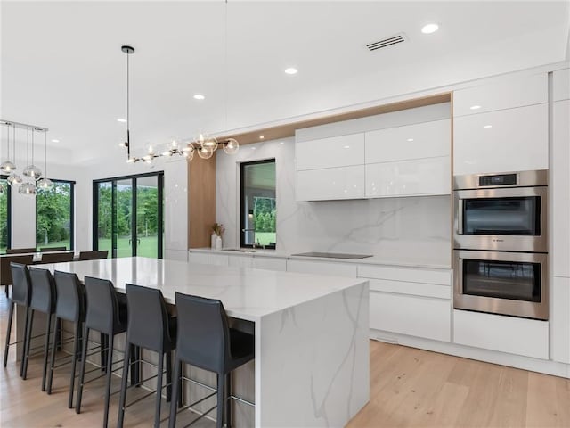 2940 Old Peachtree Rd, Dacula, GA 30019 - kitchen with modern cabinets, stainless steel double oven, white cabinets, and recessed lighting