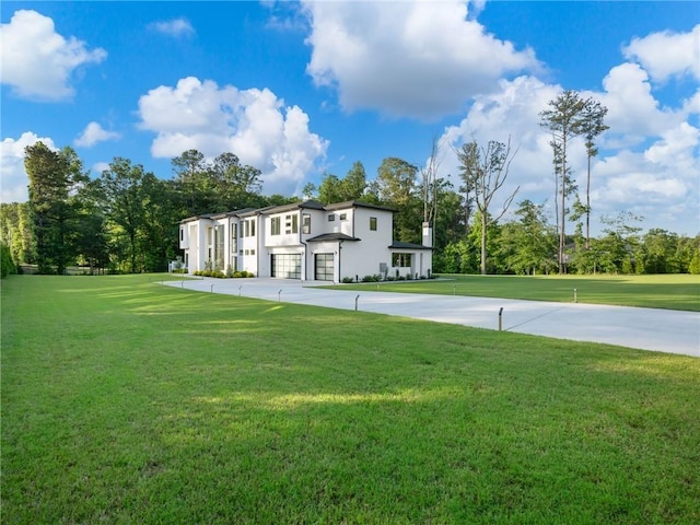 2940 Old Peachtree Rd, Dacula, GA 30019 - view of green lawn with an attached garage and view of wooded area