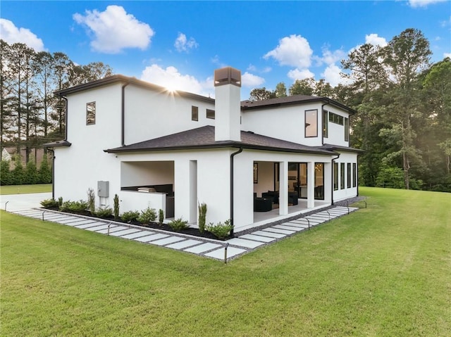 2940 Old Peachtree Rd, Dacula, GA 30019 - rear view of property with a yard, outdoor lounge area, a chimney, stucco siding, and a patio area