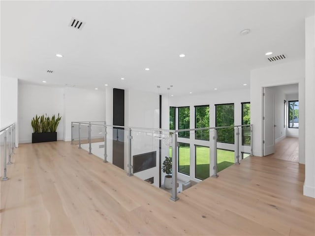 2940 Old Peachtree Rd, Dacula, GA 30019 - hall with light wood-style floors, recessed lighting, and an upstairs landing