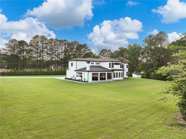 2940 Old Peachtree Rd, Dacula, GA 30019 - rear view of property with a lawn, stucco siding, a sunroom, and view of scattered trees