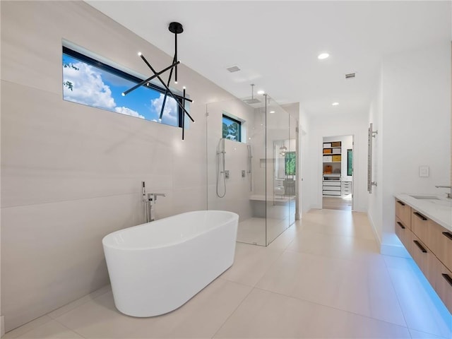 2940 Old Peachtree Rd, Dacula, GA 30019 - full bathroom featuring a shower stall, a soaking tub, vanity, and tile patterned flooring