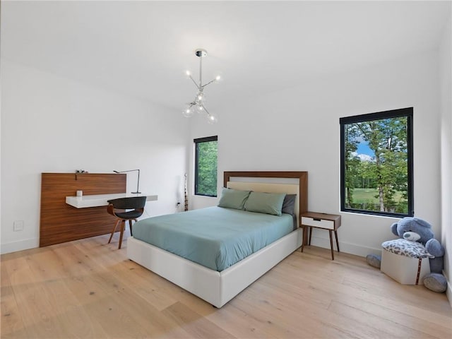 2940 Old Peachtree Rd, Dacula, GA 30019 - bedroom with wood finished floors, a chandelier, and baseboards