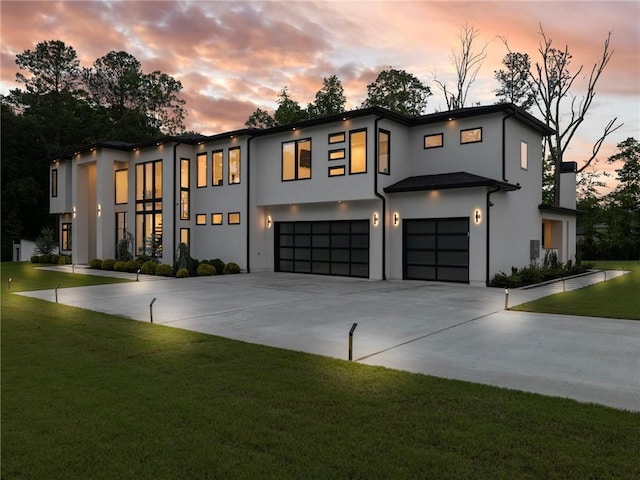 2940 Old Peachtree Rd, Dacula, GA 30019 - contemporary house featuring a garage, concrete driveway, a lawn, stucco siding, and a chimney