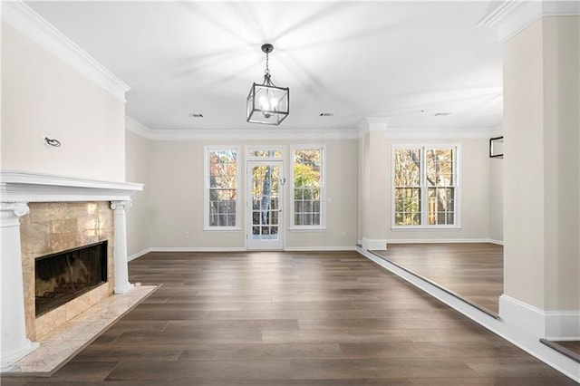 unfurnished living room with dark wood-style floors, baseboards, crown molding, and a premium fireplace