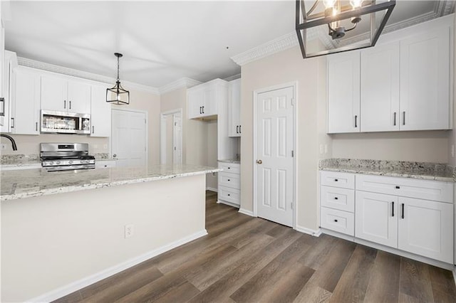 kitchen with ornamental molding, dark wood-style floors, white cabinets, light stone countertops, and stainless steel appliances