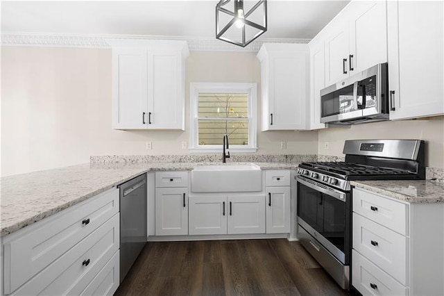 kitchen with dark wood finished floors, a sink, white cabinetry, and stainless steel appliances