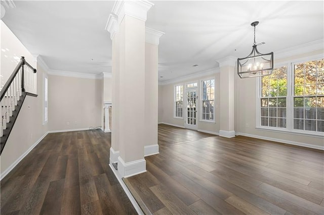 unfurnished dining area featuring dark wood-style flooring, baseboards, decorative columns, and stairway