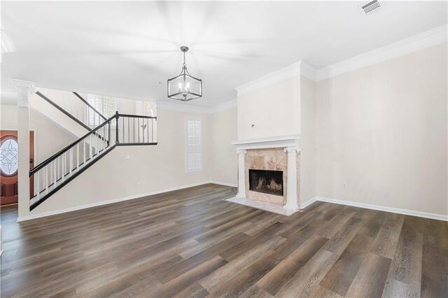 unfurnished living room featuring plenty of natural light, visible vents, and stairs