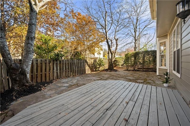 wooden deck featuring a fenced backyard and a patio area