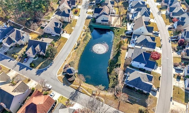 bird's eye view featuring a water view and a residential view