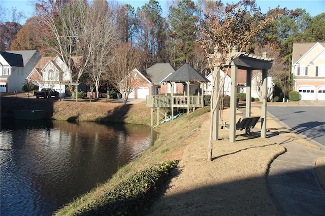view of road featuring a water view and a residential view