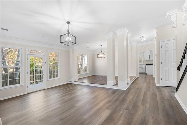 unfurnished dining area with dark wood-type flooring, visible vents, baseboards, and crown molding